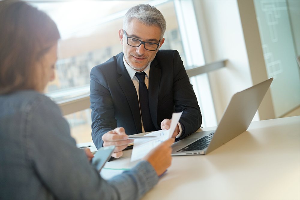 A Dodgen Security advisor reviewing a security plan with a client